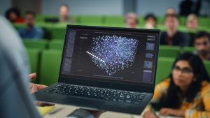 College professor showing virtual lab to students in class.