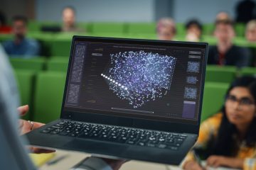 College professor showing virtual lab to students in class.