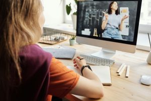 Remote student watches a dual delivery lecture given in a classroom for both remote and in-person students.